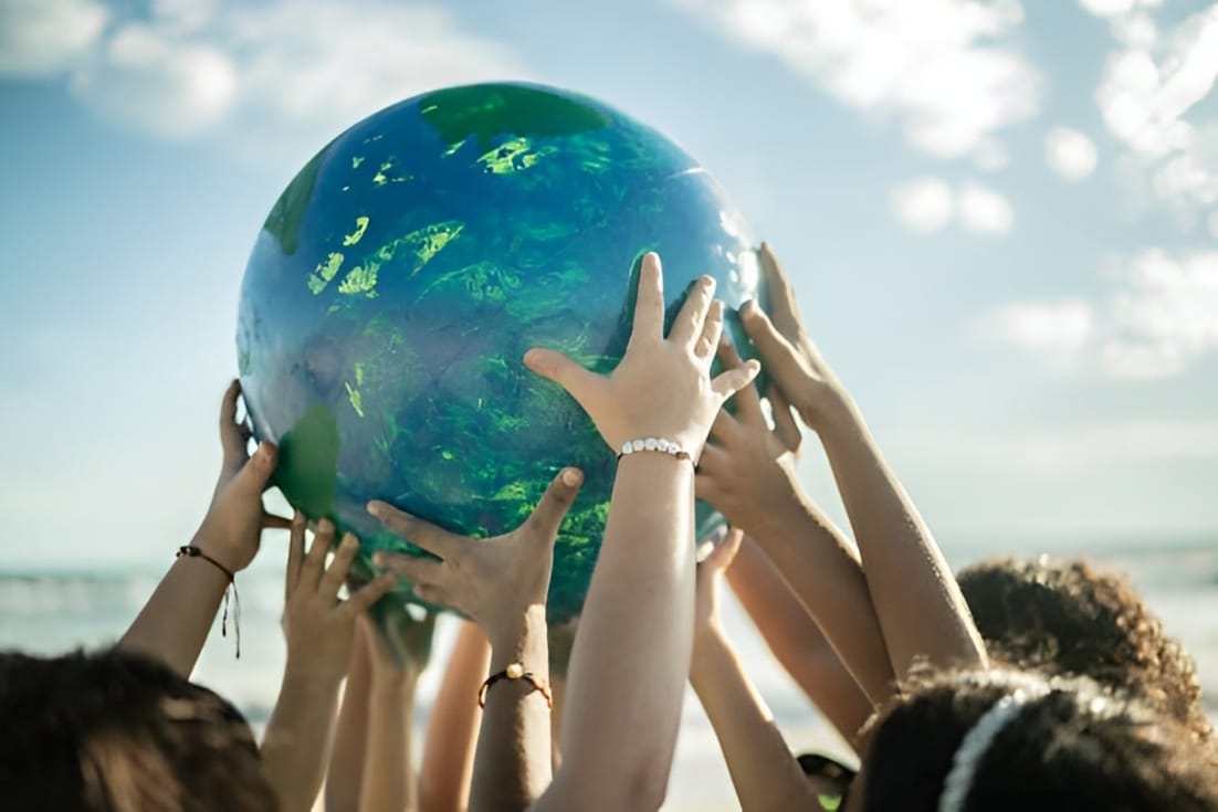 Close-up of student holding a planet at the beach