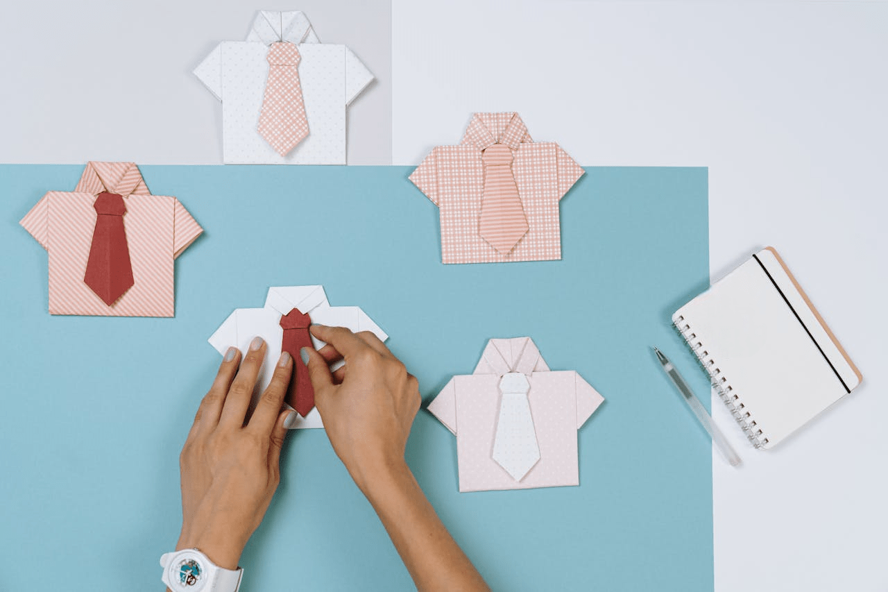 person making a shirt and tie origami