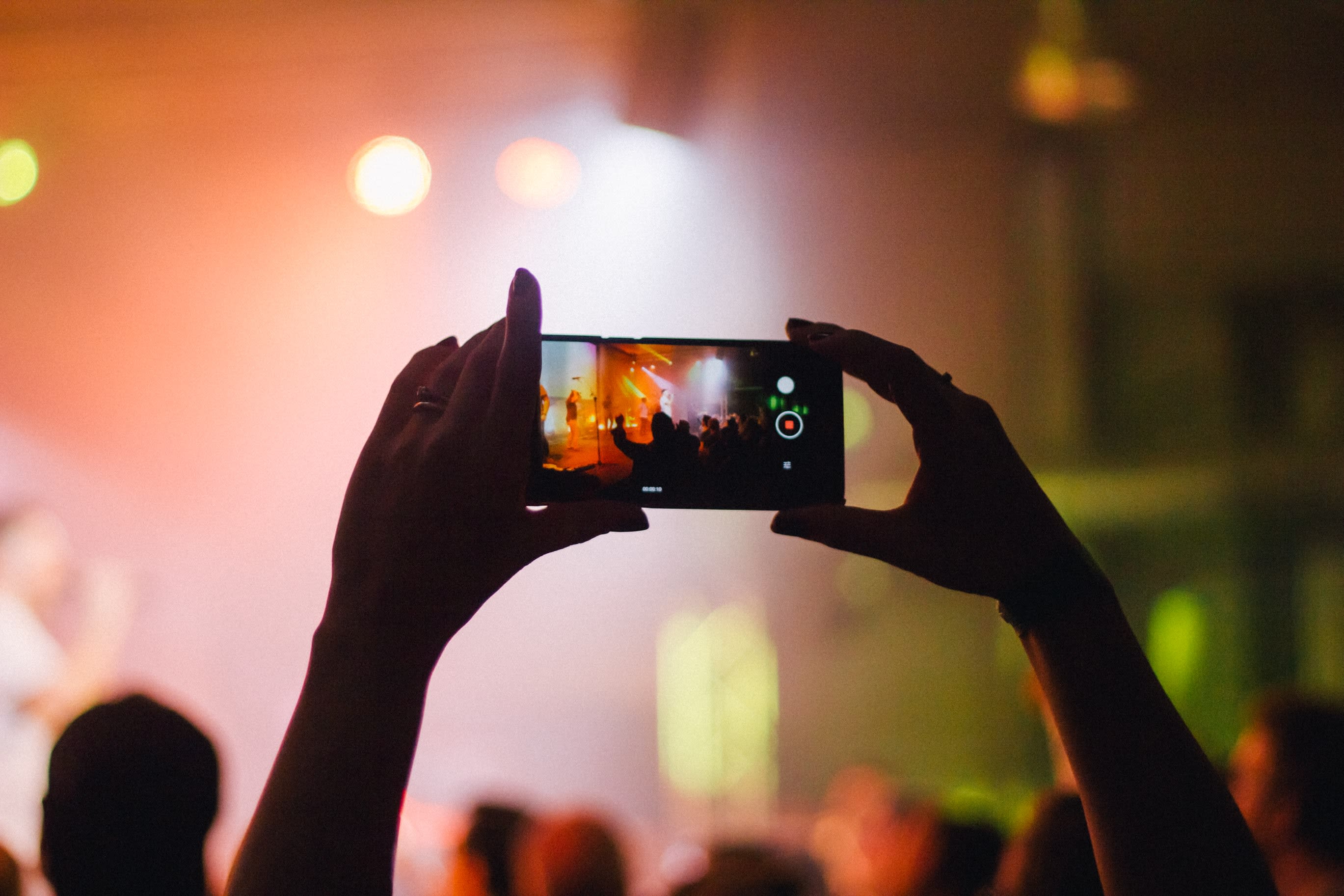 Fan taking a video at a concert.