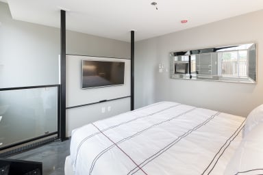 Smart TV in the bedroom. Partially glass wall. Bedroom 2