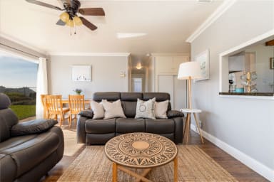 Cozy sitting area with chairs, table, and window views