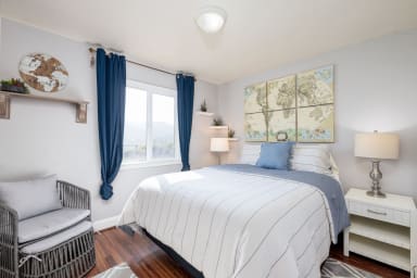 Kind size bed, lamp, drawers, window, world map