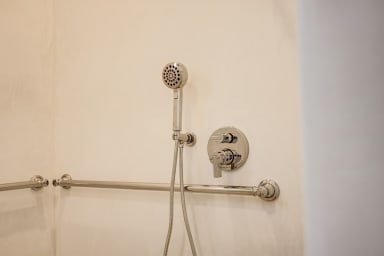 En-suite ADA bathroom with rain shower and high-end toiletries