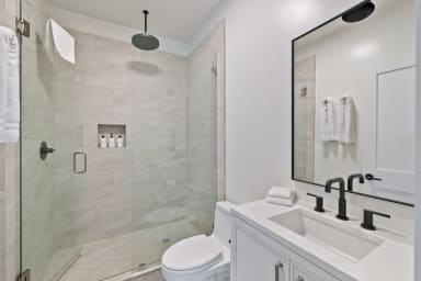 En-suite bathroom with rain shower and high-end toiletries