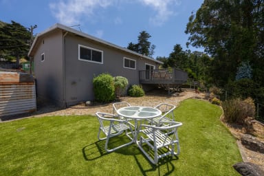 Spacious backyard with stylish chairs and table