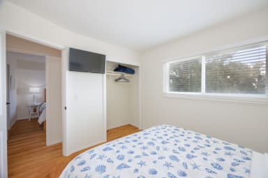 Sophisticated queen bedroom with natural light