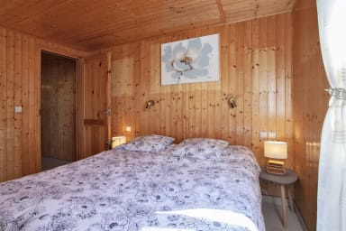 bedroom with a queen-size bed and a large dressing room with TV