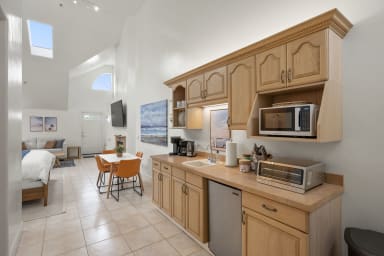 Well-equipped kitchen with coffee maker, microwave, toaster, and mini fridge
