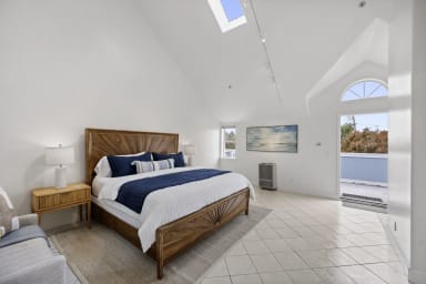 Inviting king-size bedroom featuring a cozy balcony