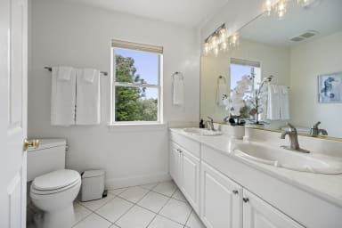 Comfortable bathroom featuring a shower and toilet for convenience