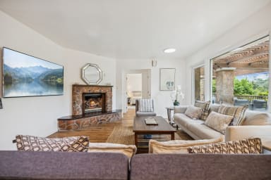 Open living room with gas fireplace and smart TV.