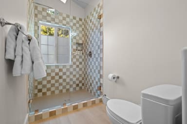 En-suite bathroom with rain shower and Public Goods toiletries.