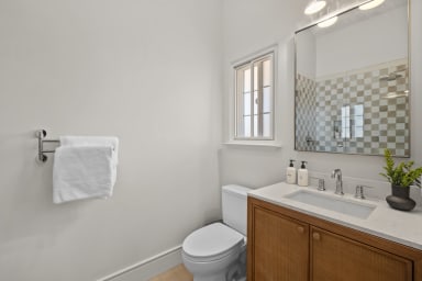 En-suite bathroom with rain shower and Public Goods toiletries.