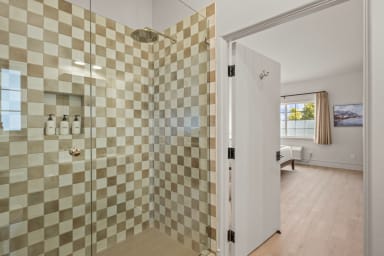 En-suite bathroom with rain shower and Public Goods toiletries.