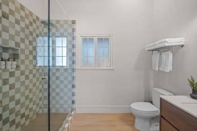 En-suite bathroom with rain shower and Public Goods toiletries.