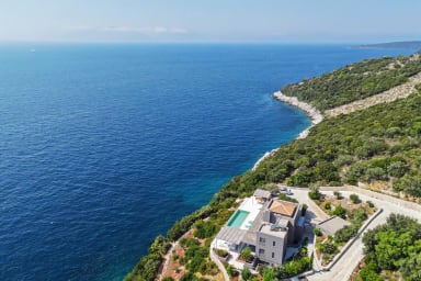 Aerial perspective reveals the villa’s lush gardens and sparkling private pool.