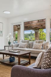 Open living room with gas fireplace and smart TV.