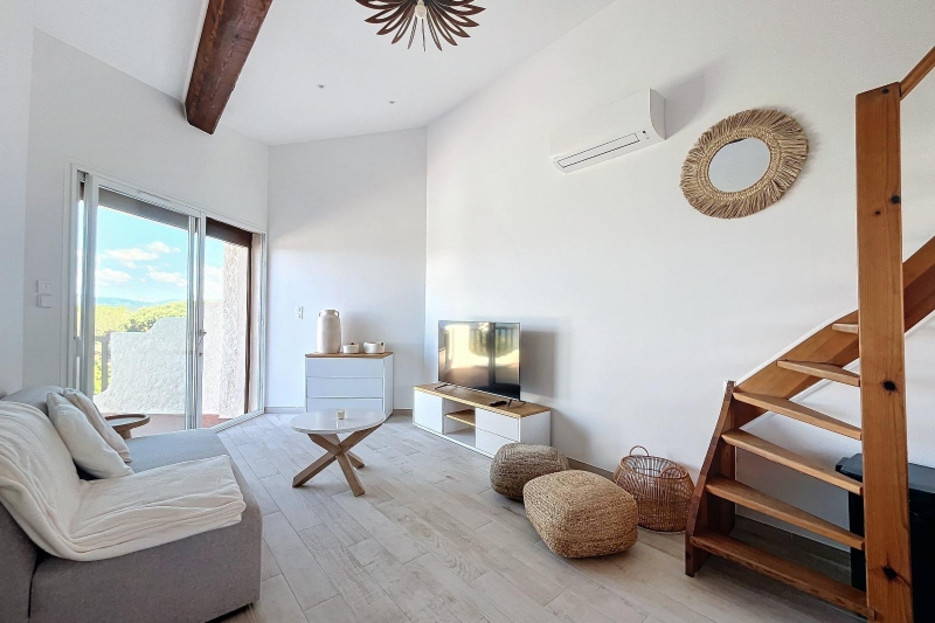Lounge area and terrace access with connected TV