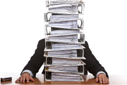 Man sat behind a stack of files