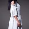 Ruffled white dress with cut-out sleeves and a removable kilt skirt