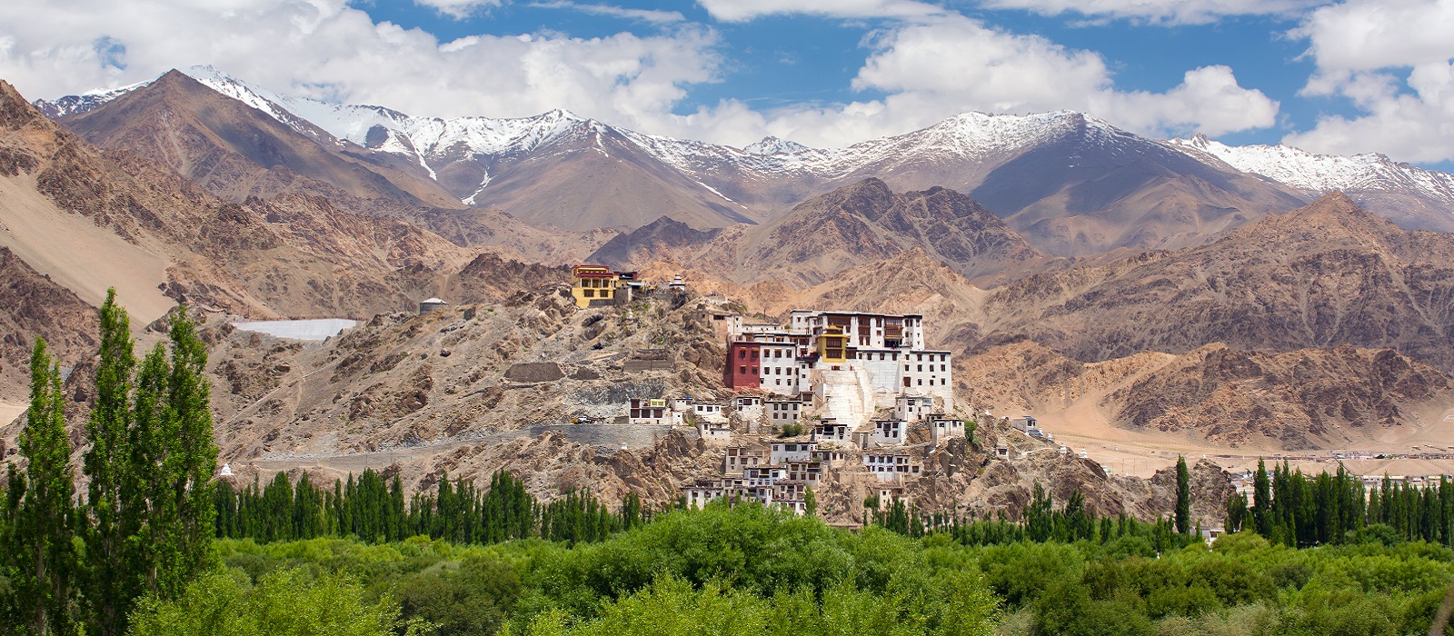 Enchanting Travels India Tours Leh Spituk Monastery with view of Himalayas mountains. Spituk Gompa is a famous Buddhist temple in Ladakh,