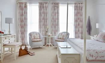 a living room filled with furniture and a bed