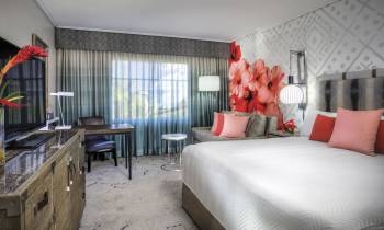 a bedroom with a bed and a chair in a room