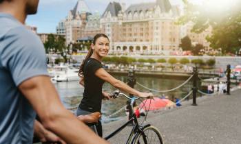 Michelle Borromeo riding on the back of a bicycle