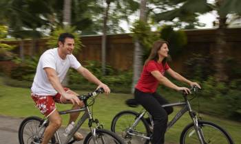 a group of people riding on the back of a bicycle