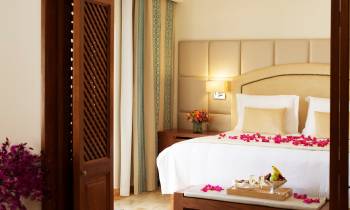 a bedroom with a bed and a table in a room