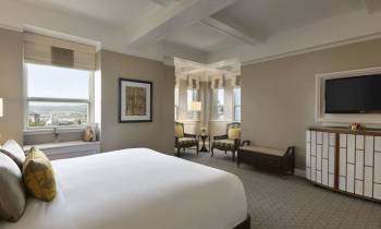 a bedroom with a large bed in a hotel room
