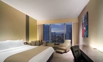 a bedroom with a large bed in a hotel room