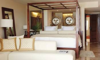 a living room filled with furniture and a mirror