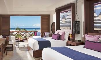 a bedroom with a bed and a chair in a room