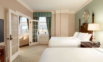 a bedroom with a bed and a mirror in a room