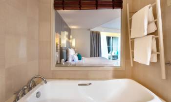 a large white tub sitting next to a sink