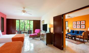 a living room filled with furniture and a bed in a bedroom