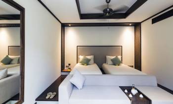 a bedroom with a bed and a mirror in a room