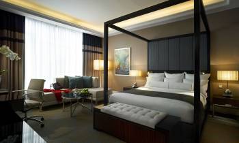 a bedroom with a large bed in a hotel room