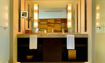 a hotel room with a sink and a mirror
