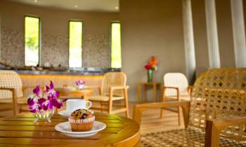 a room filled with furniture and vase of flowers on a table