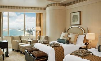 a hotel room filled with furniture and a large window