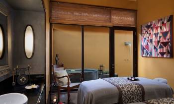 a bedroom with a bed and a mirror