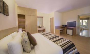 a living room with a flat screen tv sitting on top of a bed