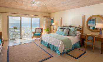 a bedroom with a bed and a chair in a room