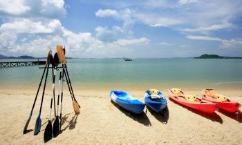 a boat sitting on top of a sandy beach