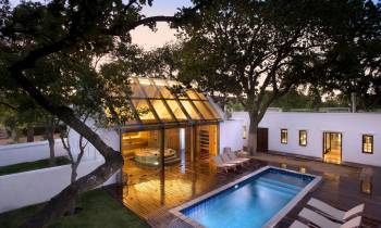 a house with a pool in front of a building