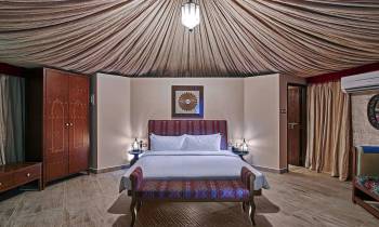 a bedroom with a large bed in a room