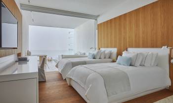 a bedroom with a bed and desk in a room
