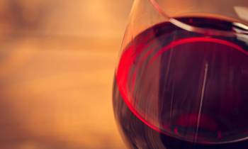 a close up of a glass of red wine
